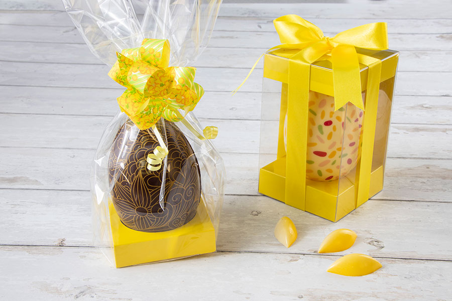 Easter-eggs-in-clear-packaging-with-canary-yellow-inserts-ribbons-and-decorations