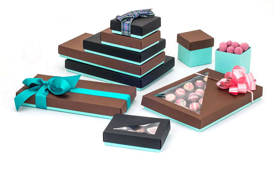 Display-of-light-blue-packaging-of-different-sizes-and-shapes-containing-an-array-of-chocolates-decorated-with-ribbons
